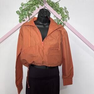 gorpcore top Burnt orange cropped windbreaker spring nature outdoors camp hike